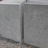 Stacked dove grey limestone hearth slabs ready for crating at our Colchester depot.