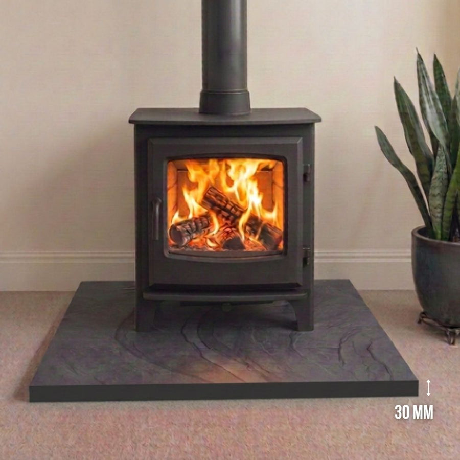 Brazilian black brushed slate hearth, 1200x900x30mm, engineered for heavy stoves. Low-sheen matte aesthetic with precision-machined tactile quality and chamfered edges. Dispatched from Milton Keynes for UK delivery.