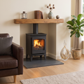 Brazilian black riven slate hearth slab, left-side angle, installed beneath a wood-burning stove