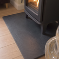 Natural riven surface texture of premium black slate hearth slab for stove