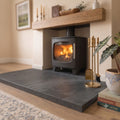 Rake angle view of a flat, smooth riven surface on a Brazilian black slate hearth that passes the credit card test.