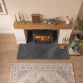 Top-down view of a 1200x900mm Brazilian slate hearth extension laid on light oak wood flooring.