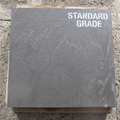 Standard Grade slate slab (Tier 01) exhibiting natural quarry character and subtle tonal variation on a wooden pallet.
