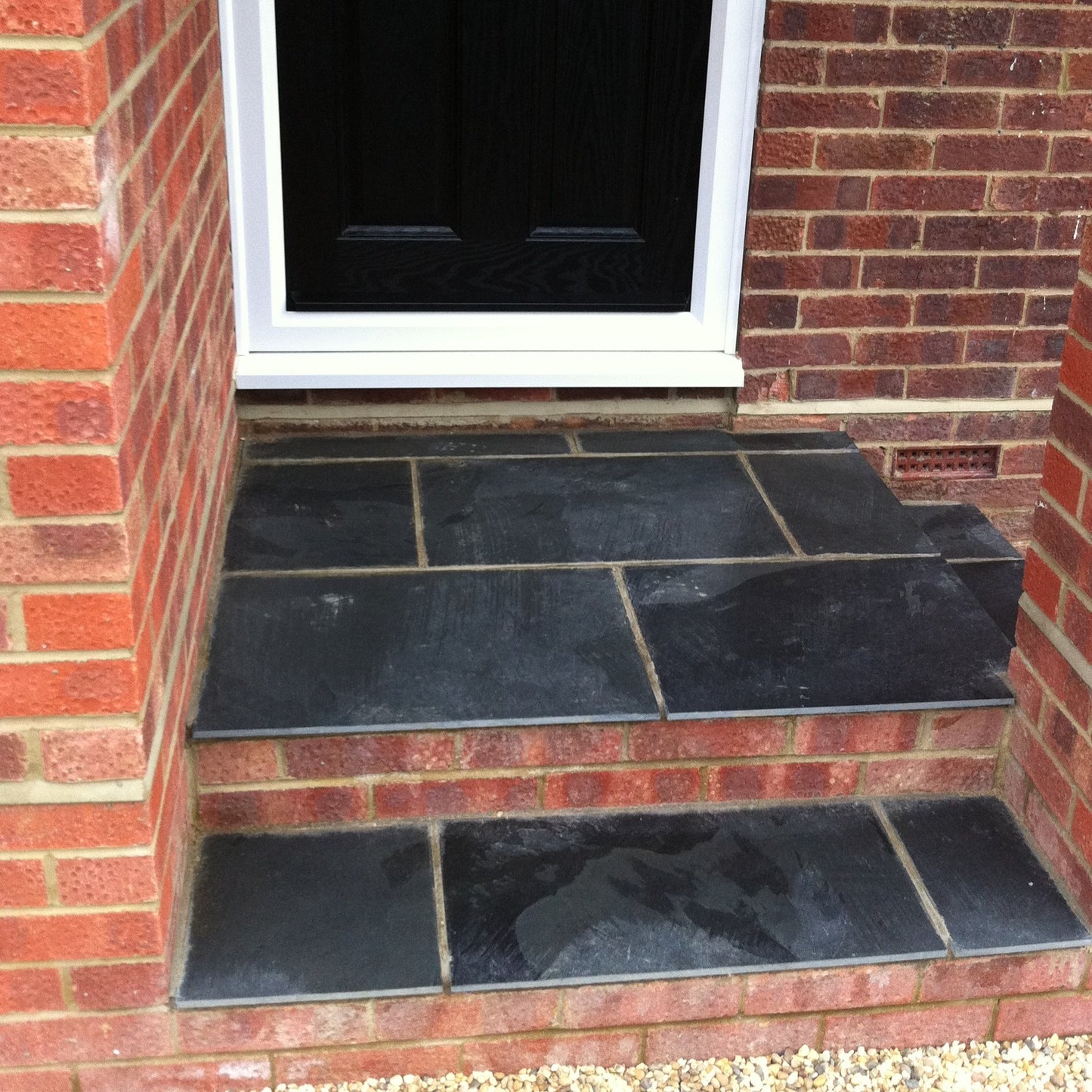 Black Slate Paving Tiles 600 x 400, customer project wet  - steps - no overhang 