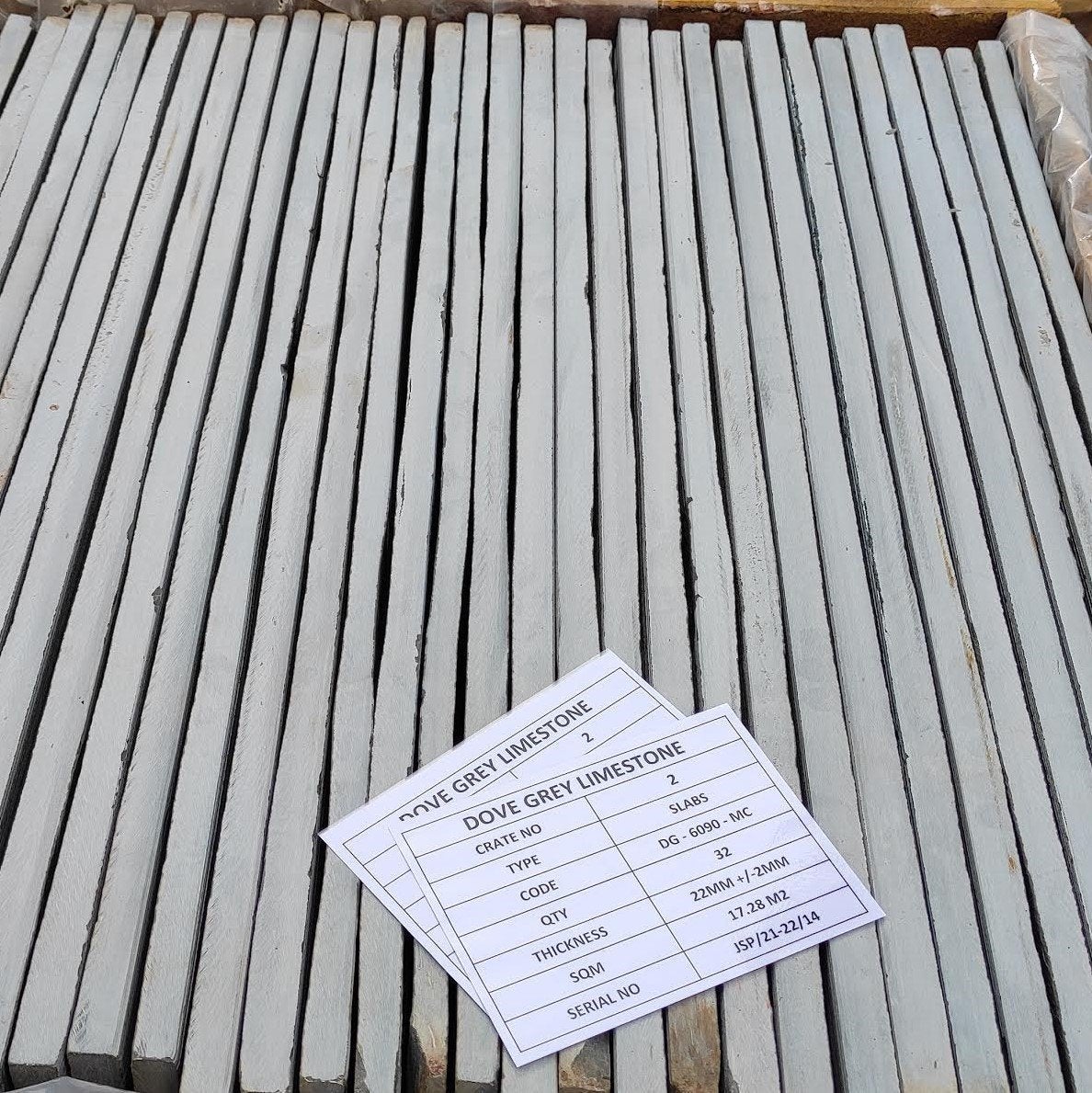 Dove grey limestone slabs in crate showing edge 
